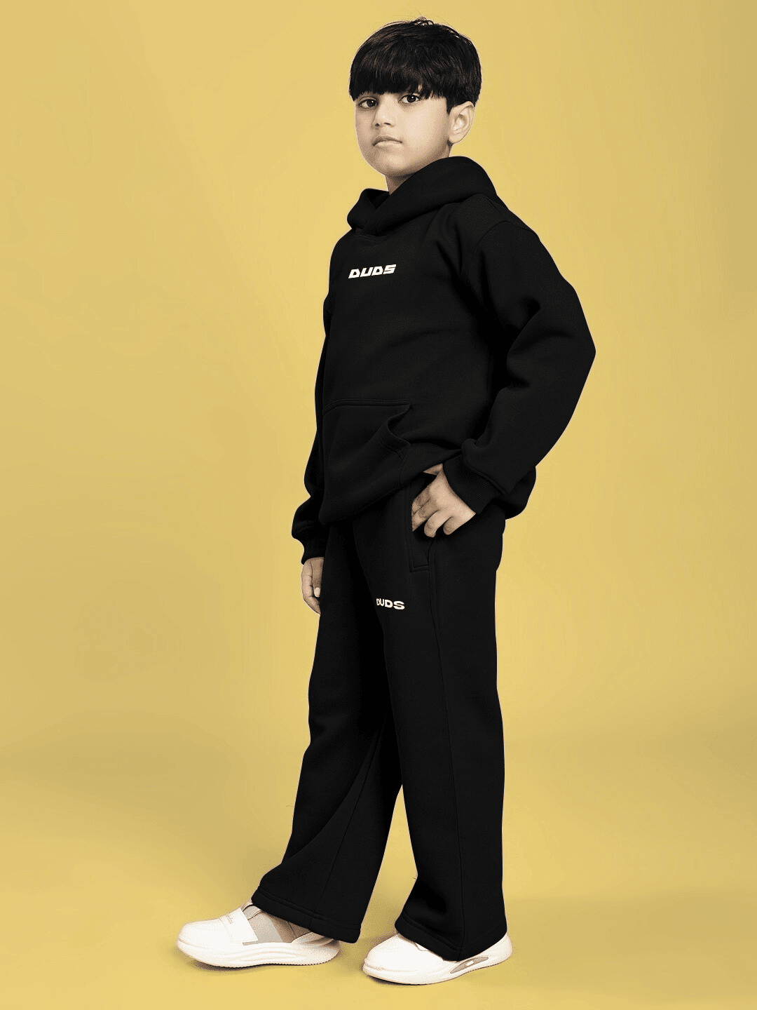 Boy wearing CHARMING CARTOON DOGS FLEECE CO-ORD FOR BOYS AND GIRLS BLACK with cartoon dog graphics, perfect for stylish and cozy wear.