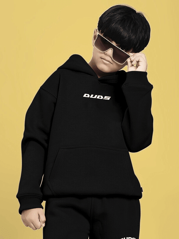 Child wearing CHARMING CARTOON DOGS FLEECE HOODIE FOR BOYS AND GIRLS BLACK with stylish sunglasses, showcasing playful fashion.