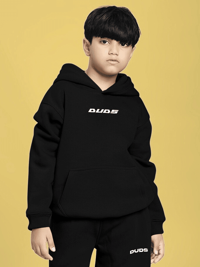 Boy wearing CHARMING CARTOON DOGS FLEECE HOODIE FOR BOYS AND GIRLS BLACK against yellow background