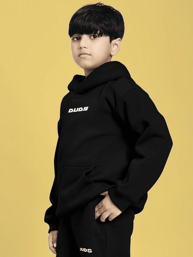 Child wearing CHARMING CARTOON DOGS FLEECE HOODIE FOR BOYS AND GIRLS BLACK, showcasing fun cartoon dog graphics and cozy style.