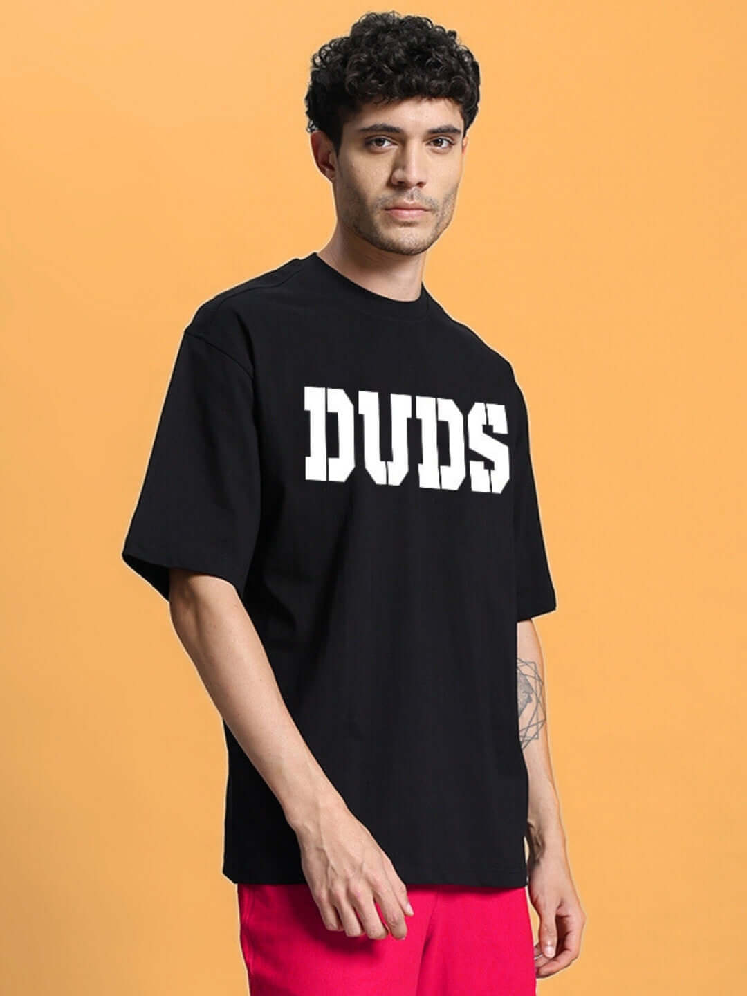 CHERRY BLOSSOM OVER-SIZED T-SHIRT BLACK made from premium cotton fabric, male model wearing it against a simple background.