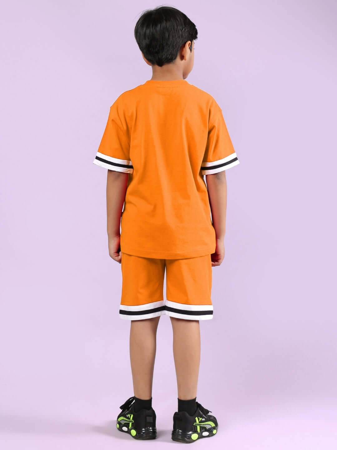 Child wearing CHICAGO PRINTED CO-ORD FOR BOYS & GIRLS ORANGE outfit.