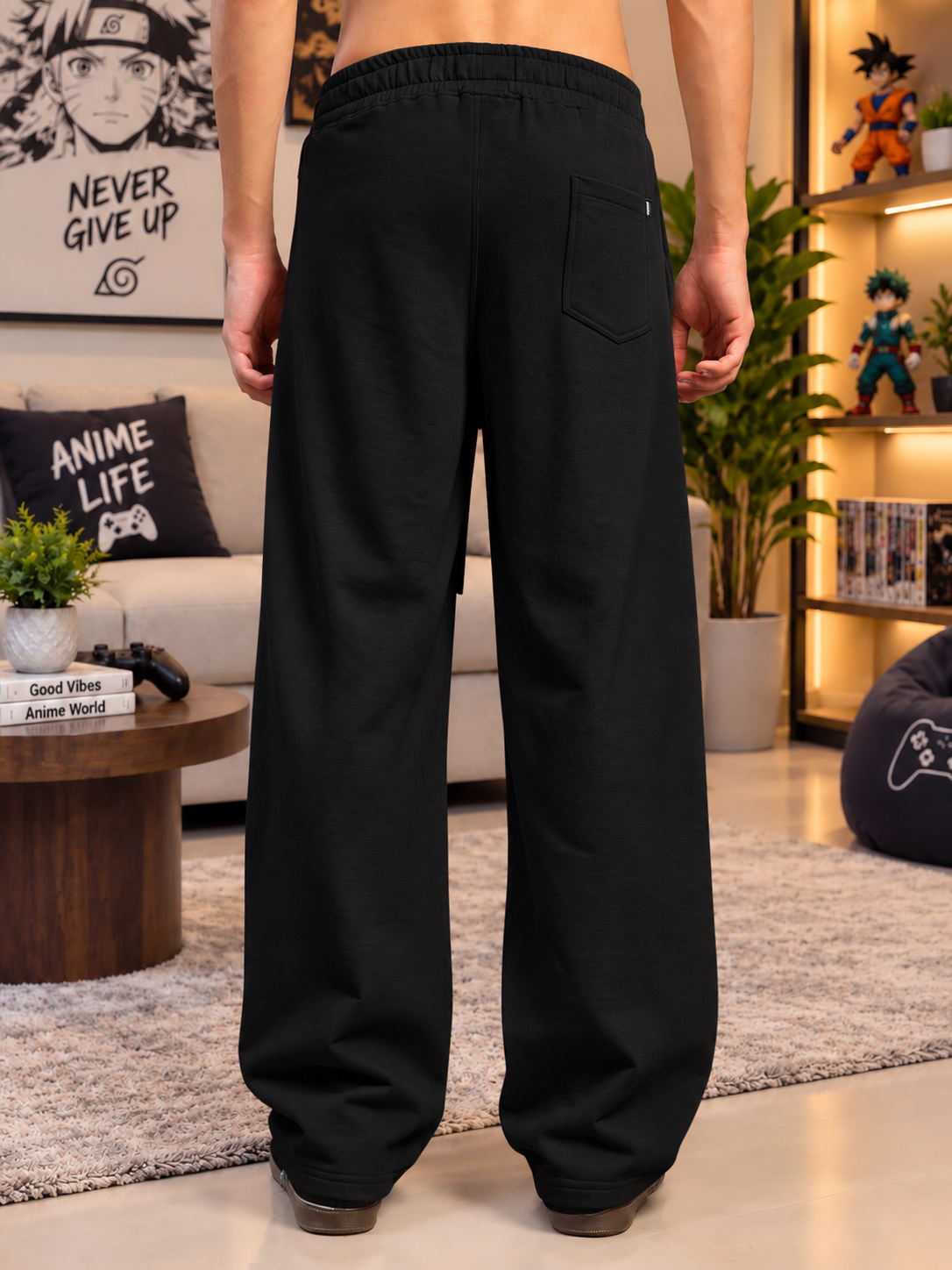 CHILL GRAPHIC COTTON TERRY JOGGERS BLACK - back view in cozy anime-themed living room