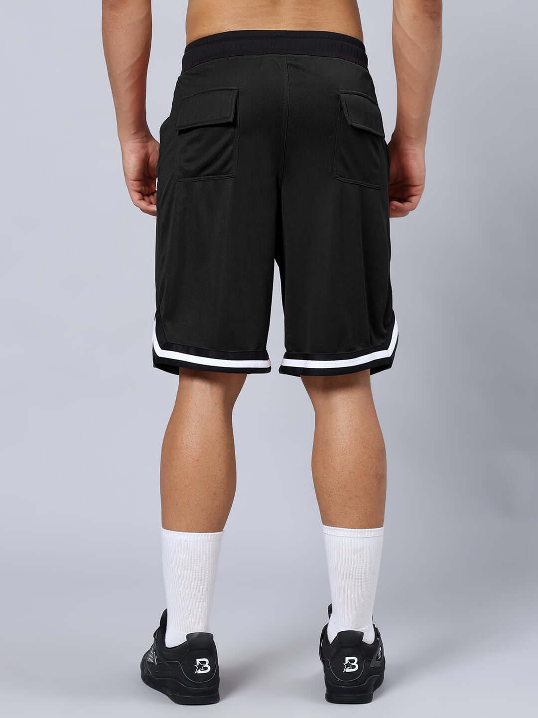 Back view of CHRONIC REGULAR FIT SHORTS BLACK, showcasing customizable fit options and stylish design with white trim accents.