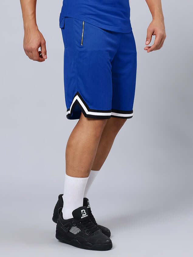 Model wearing Chronic Regular Fit Blue Shorts, featuring a zip pocket and black sneakers. Perfect for casual style.