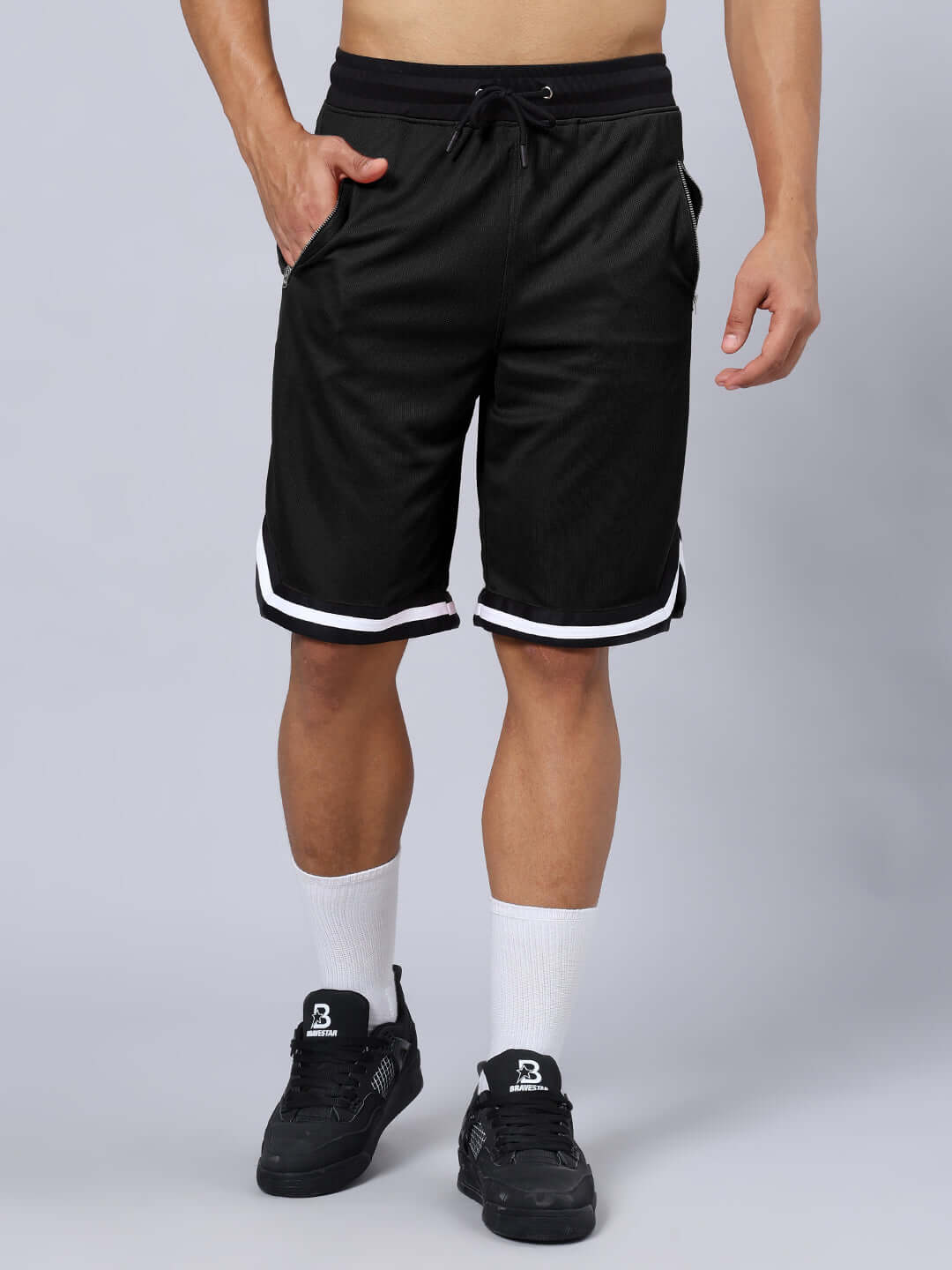 Man wearing CHRONIC REGULAR FIT SHORTS BLACK with white socks and black shoes.