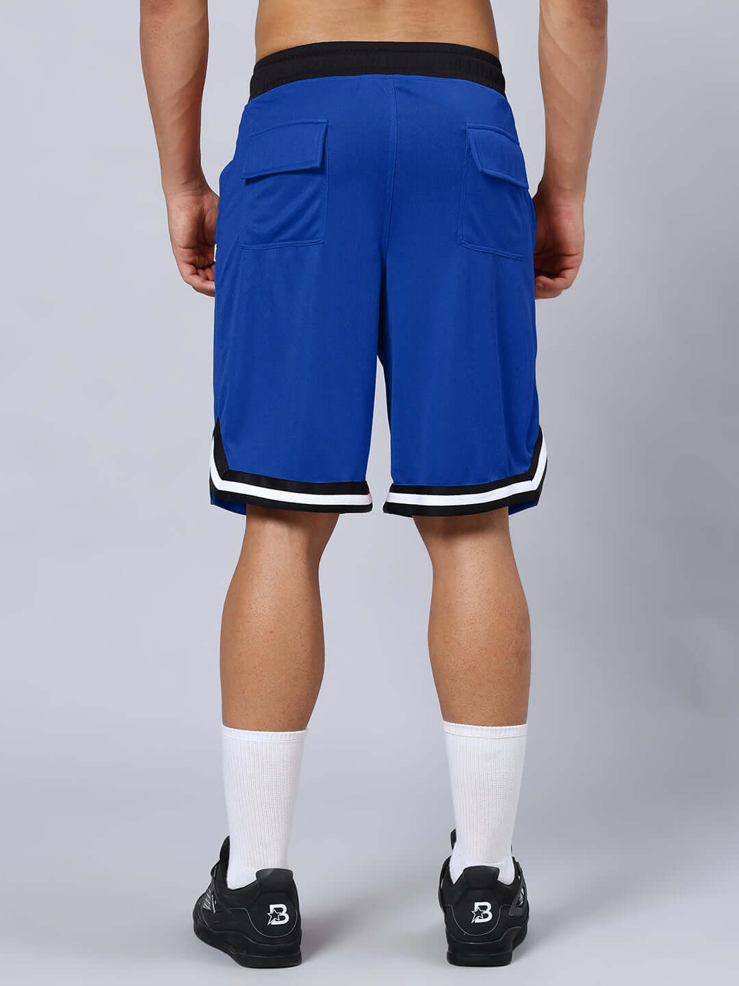 Back view of blue Chronic Regular Fit Shorts with customizable size option for a tailored fit, worn by a model.