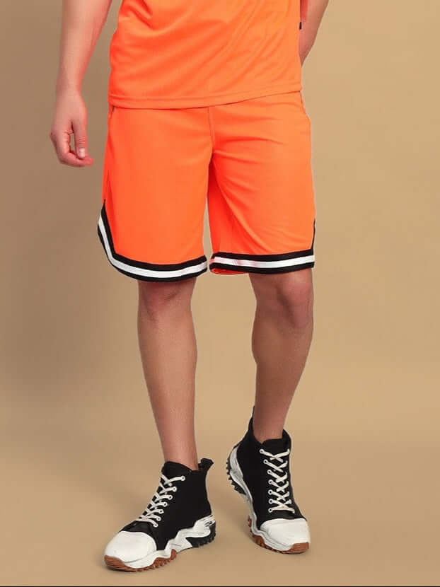 Person wearing CHRONIC REGULAR FIT SHORTS ORANGE with sneakers against a neutral background.