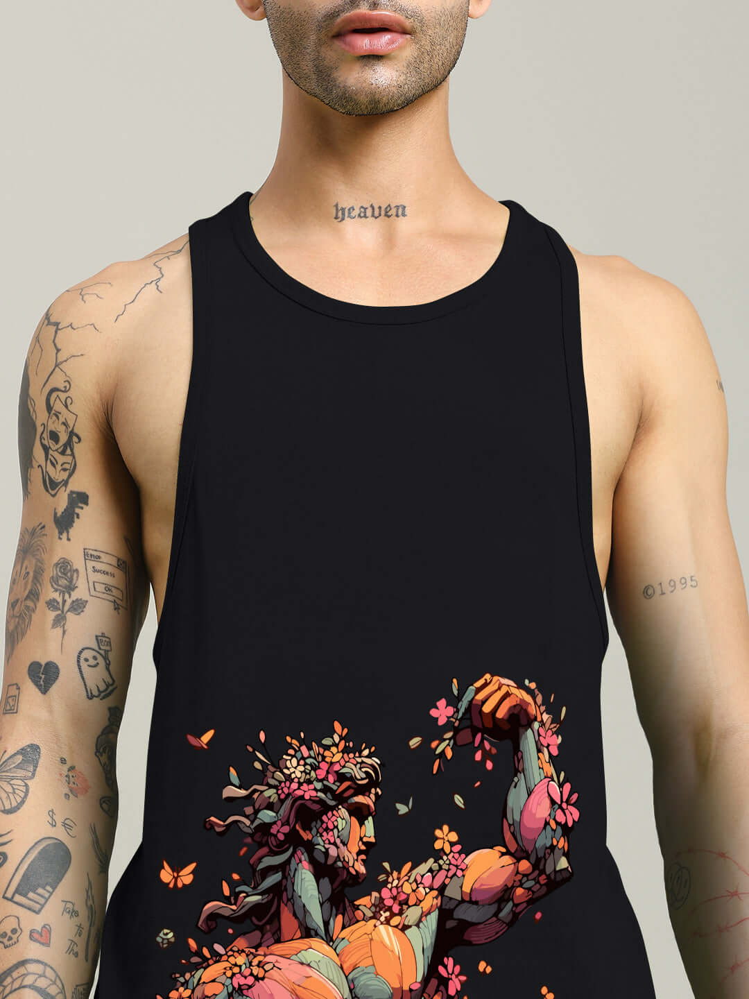 Black Classical Greek gym tank top with vibrant floral design and unique tattoos shown on model.
