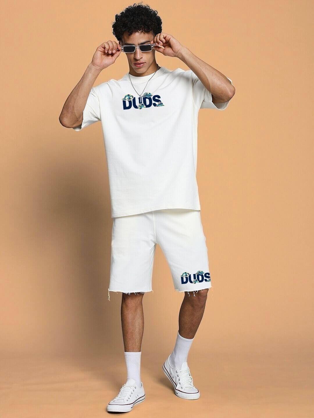 Man wearing CLOUD PRINTED CO-ORD SET OFF WHITE with casual sneakers and sunglasses, featuring a cloud design for stylish casual outings.