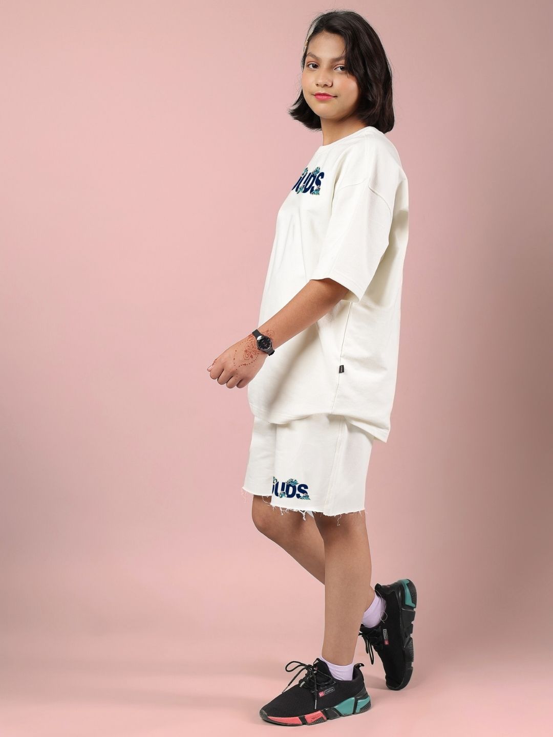 Child wearing CLOUD PRINTED CO-ORD FOR BOYS AND GIRLS OFF WHITE, featuring a casual and stylish design on a pink background.