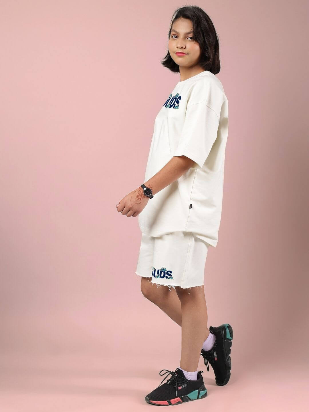 Child wearing CLOUD PRINTED CO-ORD FOR BOYS AND GIRLS OFF WHITE, featuring soft off-white cotton with cloud prints, in a fashion pose.