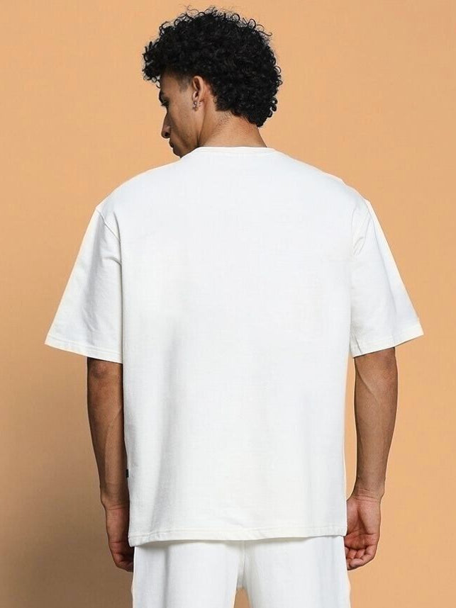 Back view of CLOUD PRINTED OVERSIZED T-SHIRT OFF WHITE on model, featuring a relaxed fit and soft cotton fabric.