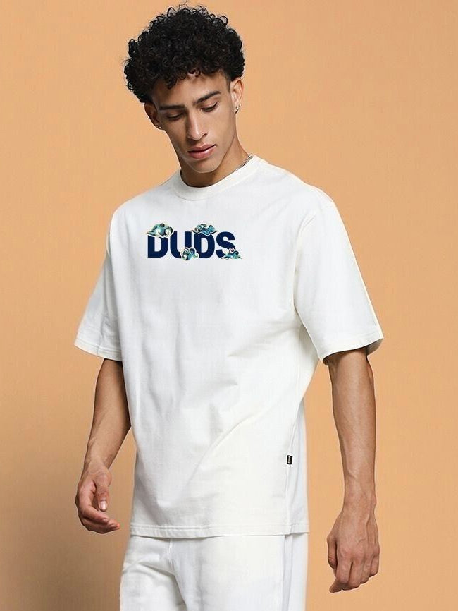 Model wearing CLOUD PRINTED OVERSIZED T-SHIRT OFF WHITE with cloud design on front, offering a trendy and relaxed style.