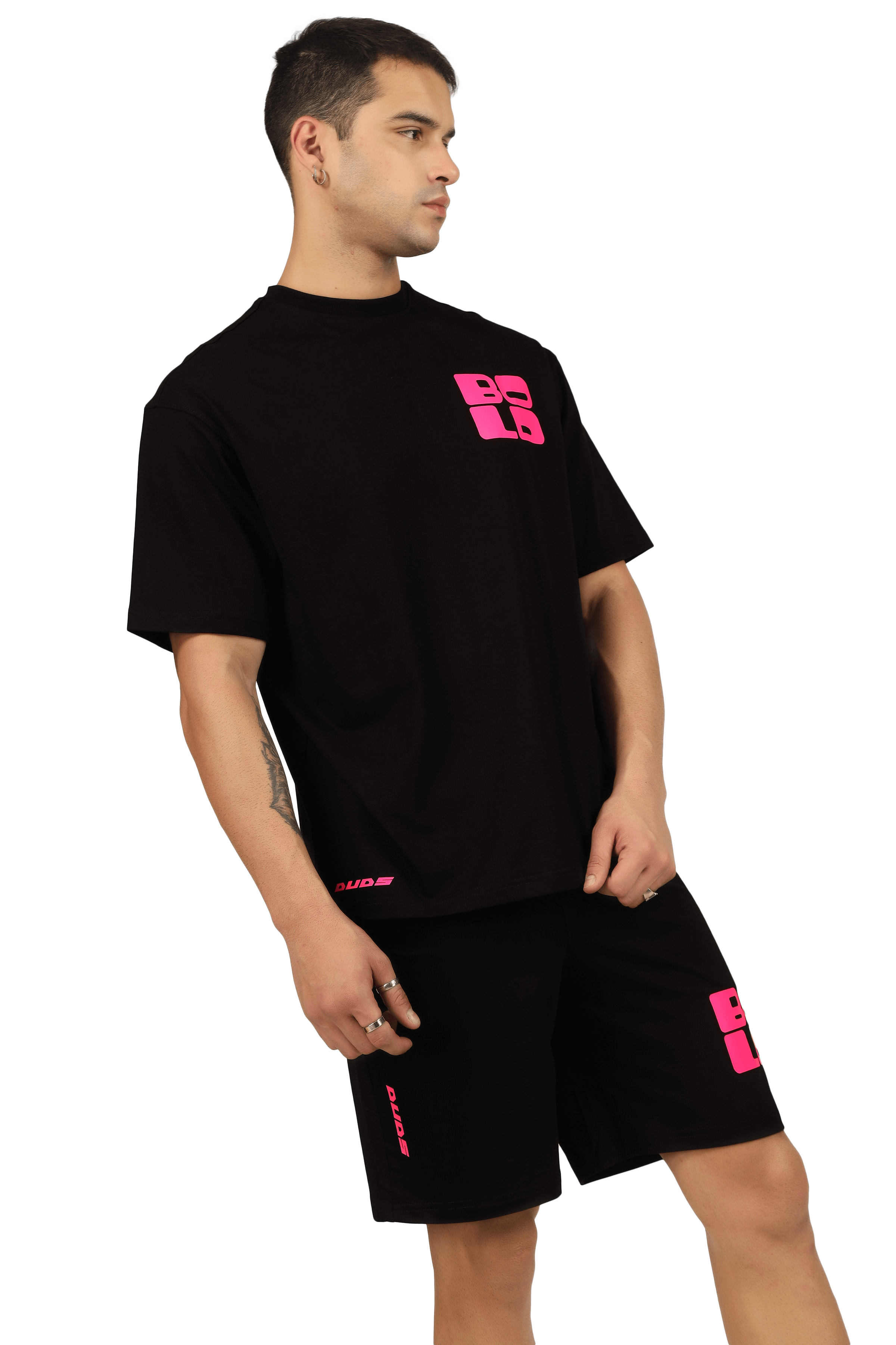 Model wearing black CO-ORD set with bold pink print, featuring customizable fit options. Stylish and trendy ensemble by DUDS.