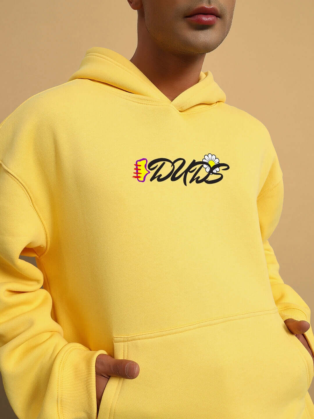 Model wearing CONFUSED FLEECE OVERSIZED HOODIE YELLOW showcasing vibrant streetwear style.