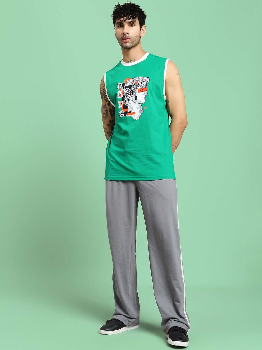 Men wearing CONTRAST PANEL COTTON TERRY JOGGER GREY with green sleeveless shirt. Casual and stylish outfit.