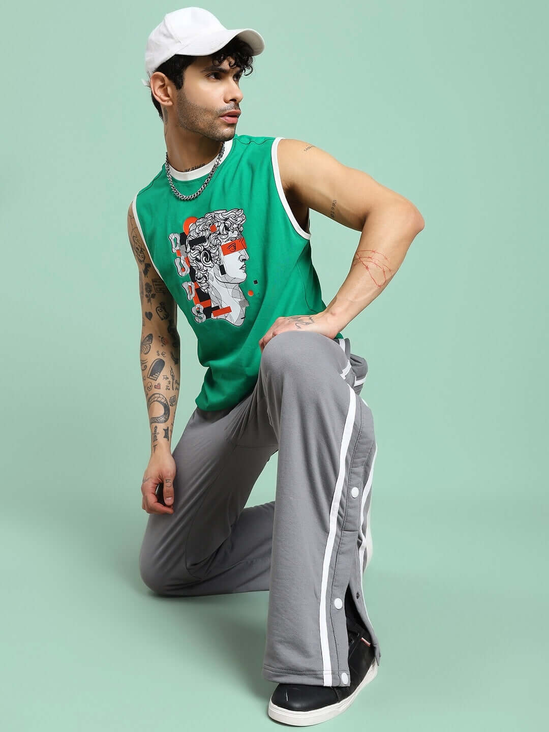 Model wearing grey CONTRAST PANEL COTTON TERRY JOGGER with green graphic tank top