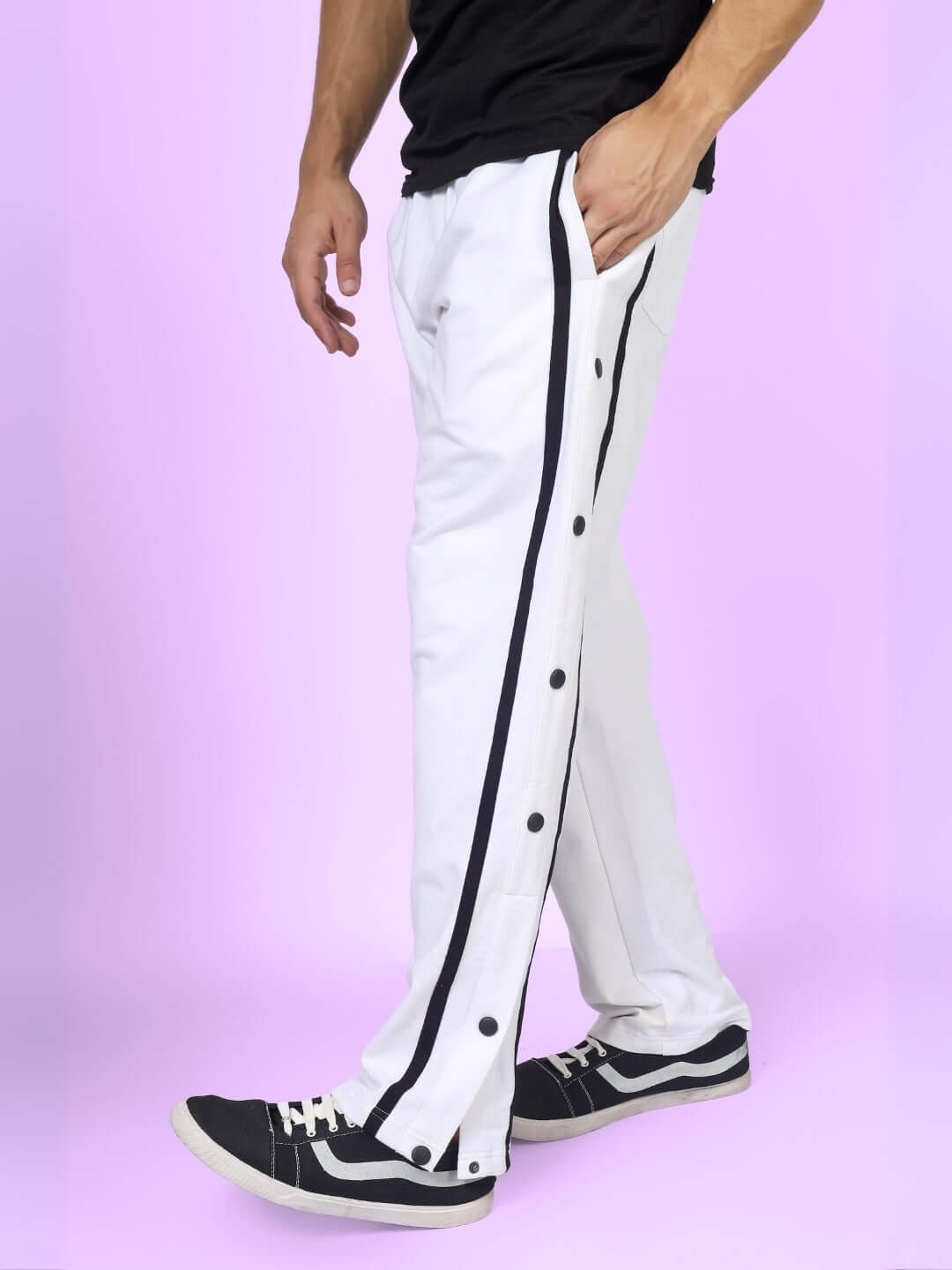 White joggers with black contrast panel and button detail, made by DUDS, worn by model.