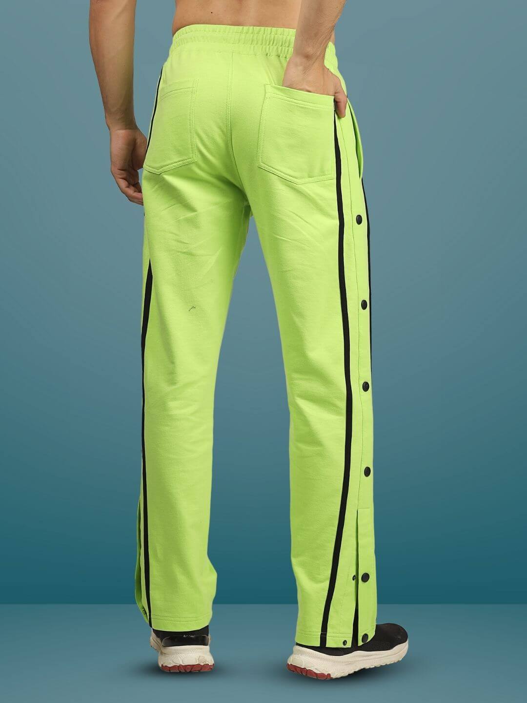 Neon green contrast panel joggers with black accents, featuring a back pocket and side buttons, designed for customizable fit.