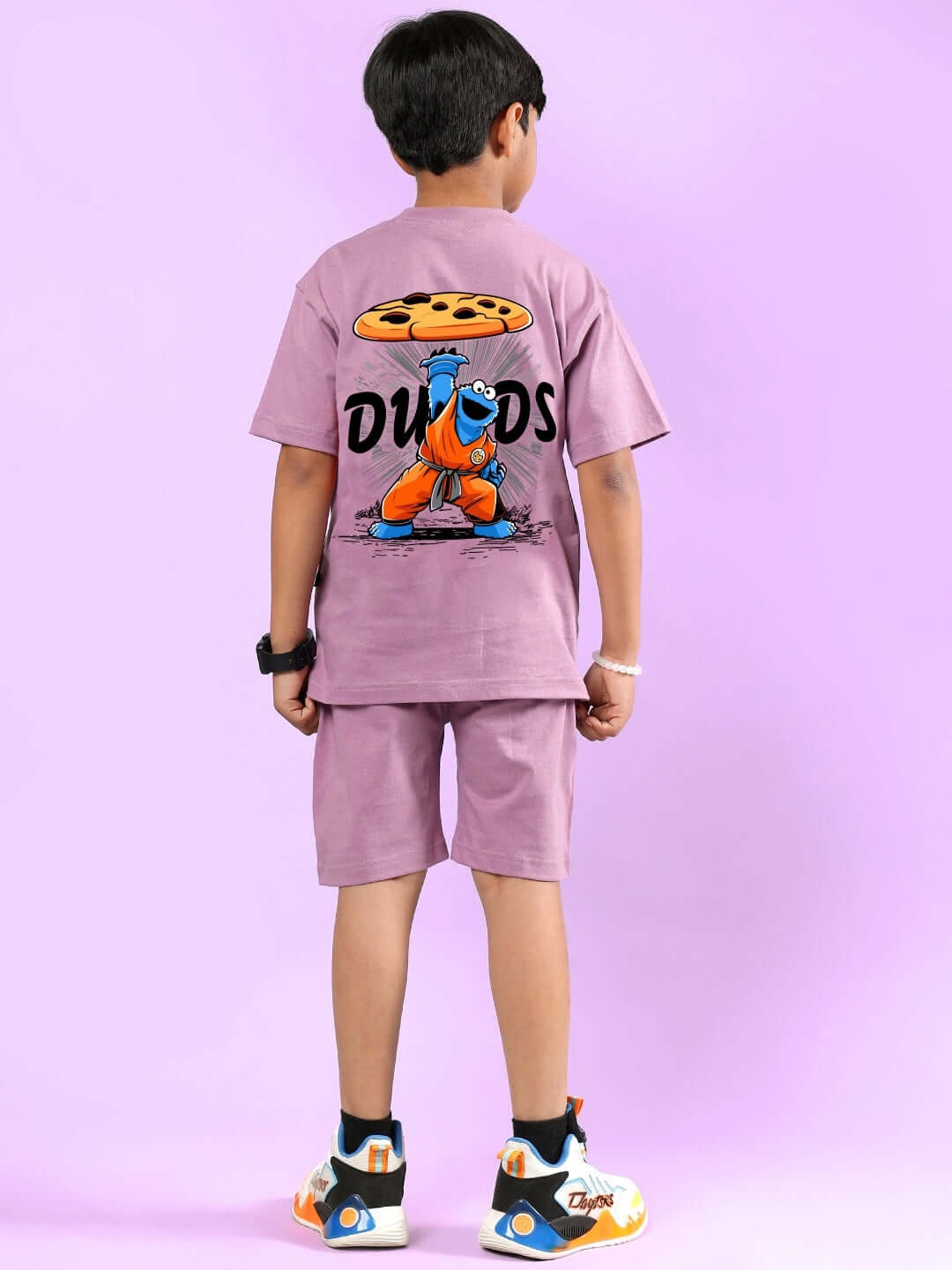 Boy wearing COOKIE MONSTER PRINTED CO-ORD FOR BOYS & GIRLS PLUM PURPLE, featuring character print on shirt, from DUDS collection.