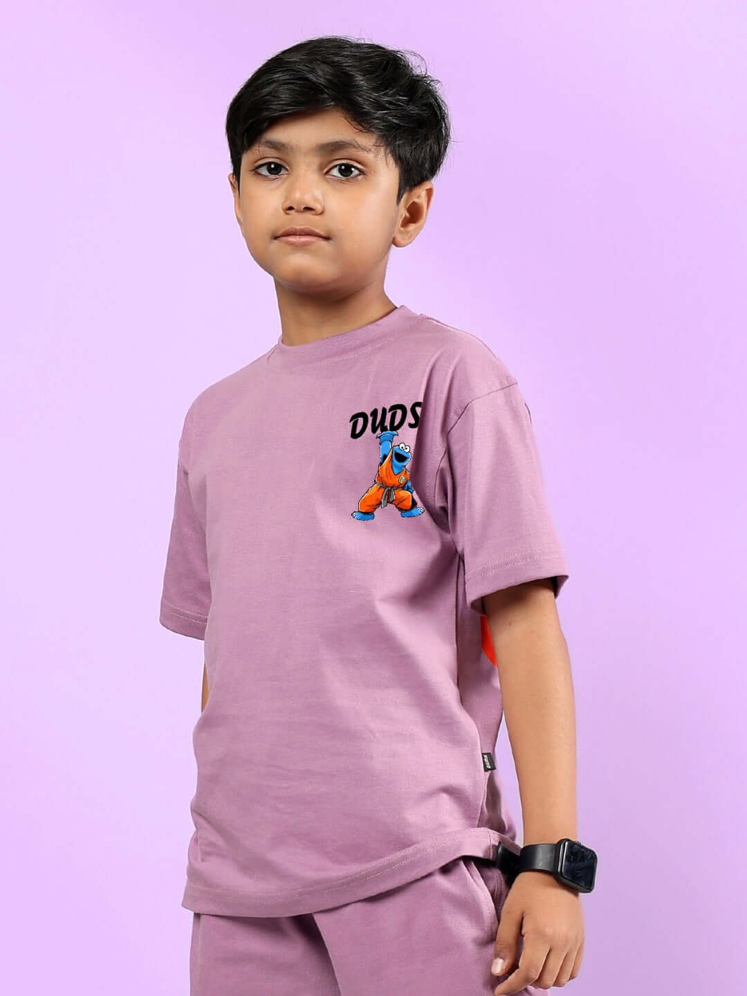 COOKIE MONSTER PRINTED T-SHIRT FOR BOYS & GIRLS PLUM PURPLE worn by a child with a purple background.
