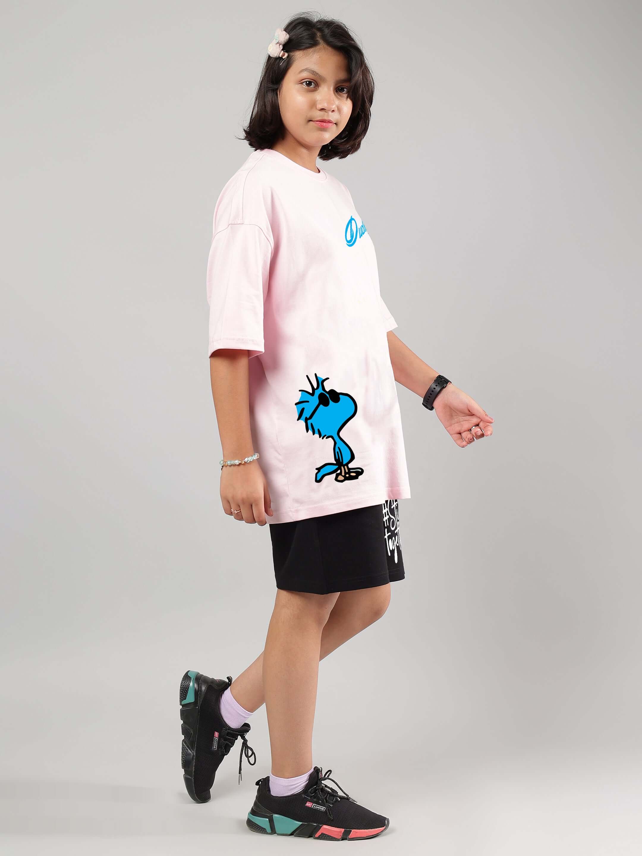 Child wearing COOL PALS CO-ORD FOR BOYS GIRLS PINK-BLACK set, featuring a pink shirt and black shorts, showcasing trendy streetwear style.