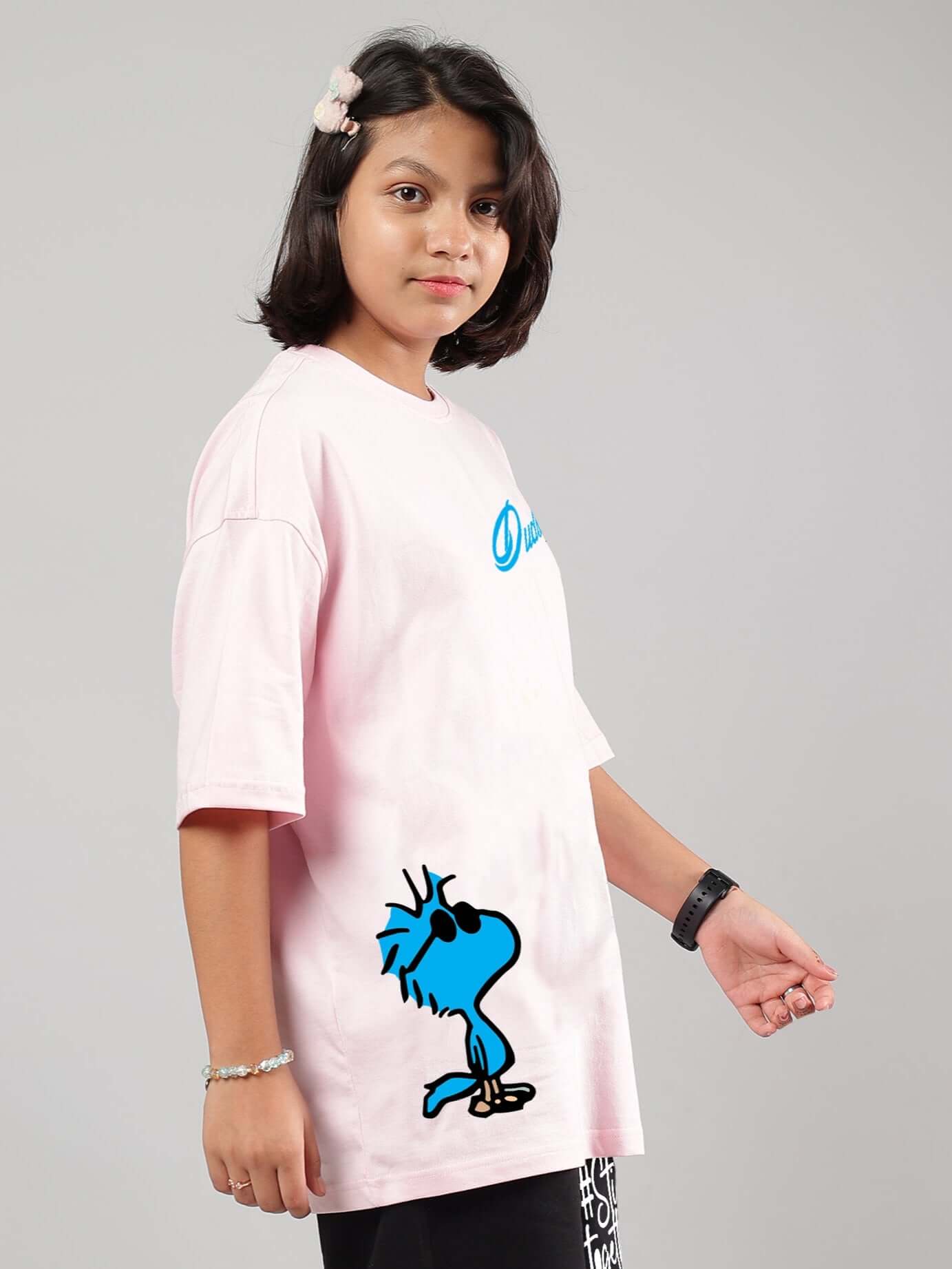 Child wearing COOL PALS OVERSIZED T-SHIRT FOR BOYS GIRLS PINK, showcasing playful streetwear style in breathable cotton.