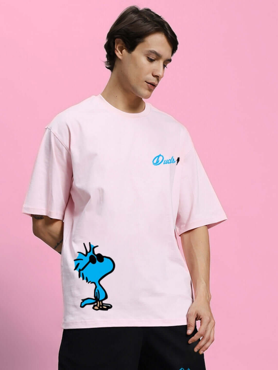Man wearing COOL PALS PRINTED OVERSIZED T-SHIRT PINK with cartoon design on front. Premium cotton, bio-washed t-shirt with relaxed fit.
