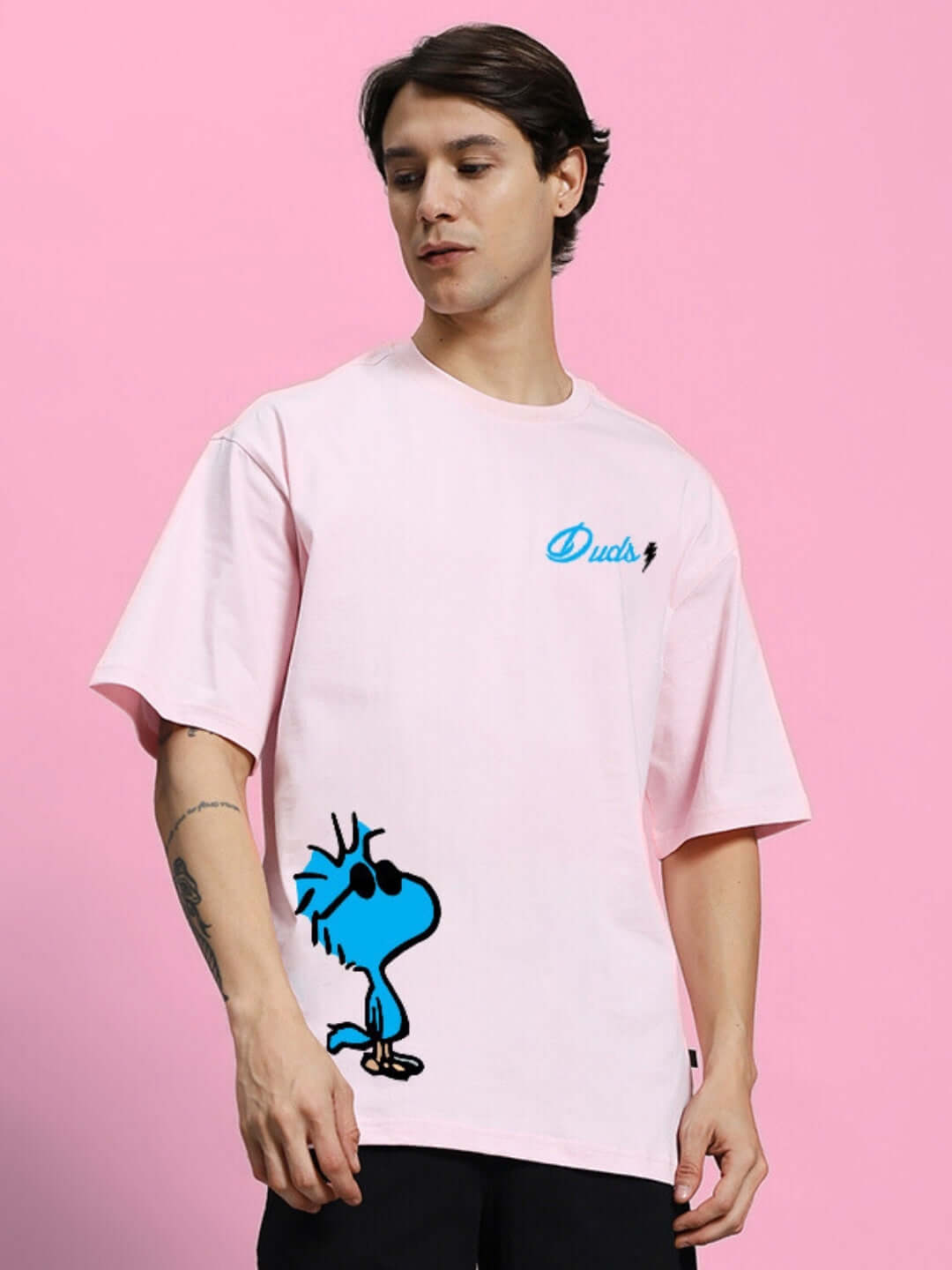 Model wearing COOL PALS PRINTED OVERSIZED T-SHIRT PINK, featuring cartoon graphic, made from premium heavy gauge 100% cotton fabric.