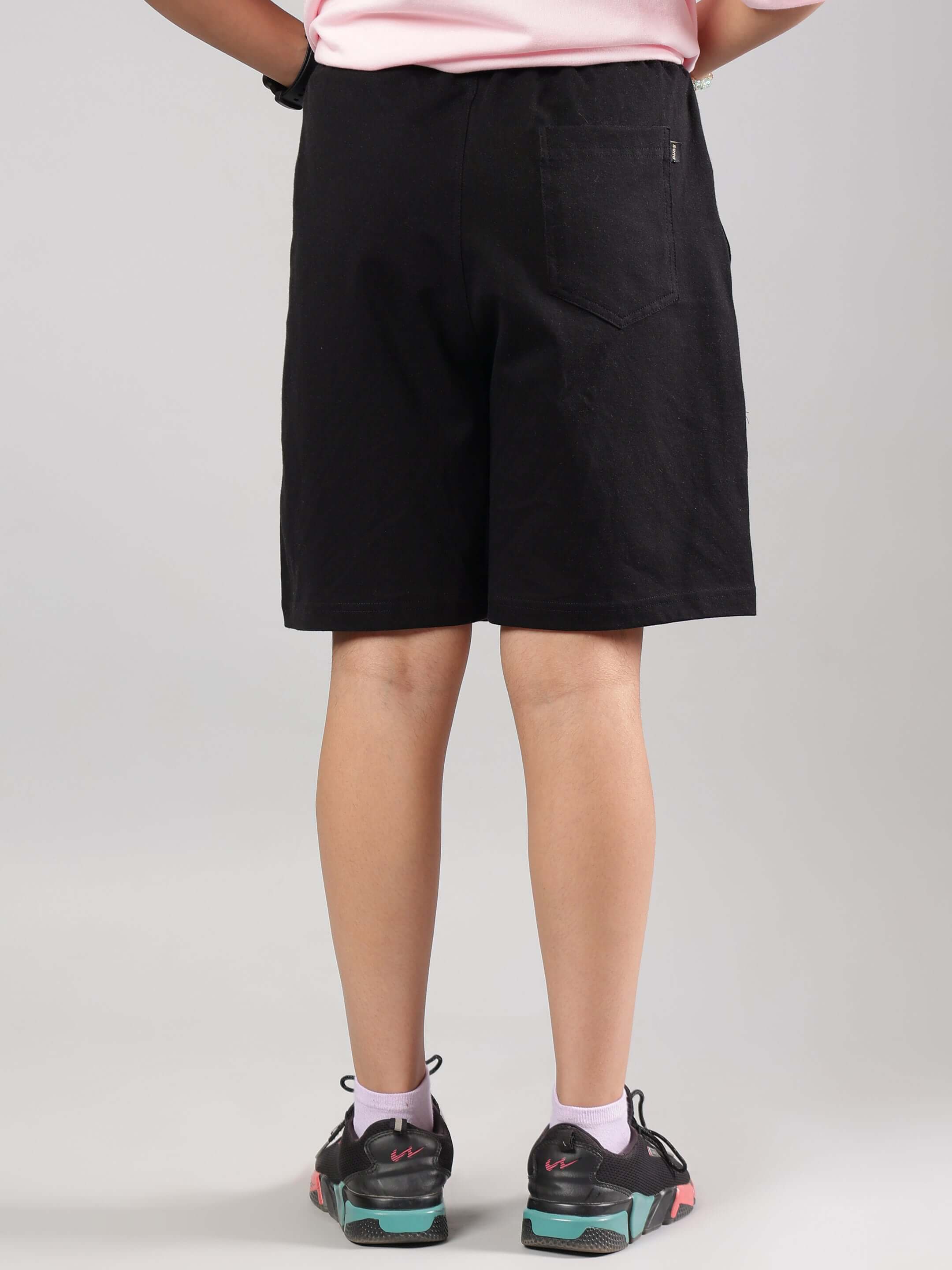 Child wearing COOL PALS SHORTS FOR BOYS GIRLS BLACK, showcasing comfortable and stylish summer wear from the back view.