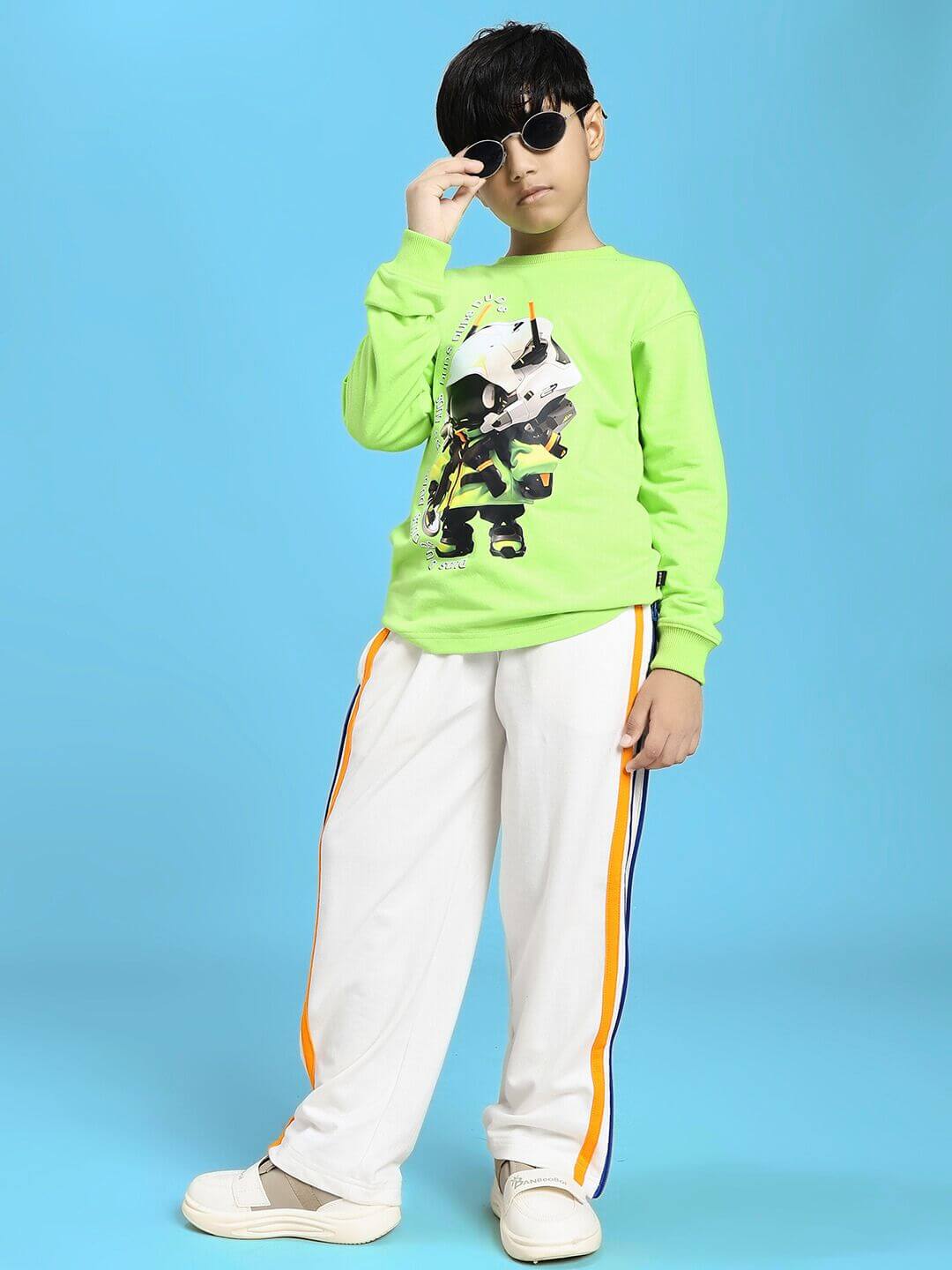 Child wearing Mini Robotics Sweatshirt for Boys and Girls Neon Green, featuring a futuristic design, standing against a blue background.