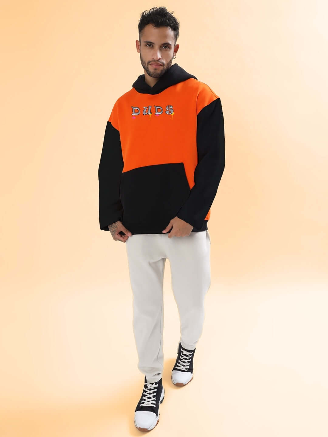 Model wearing COOL TEDDY FLEECE COLORBLOCK OVERSIZE HOODIE ORANGE BLACK, showcasing street style with vibrant orange and black design.
