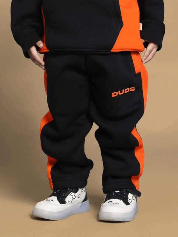 Black and orange teddy fleece pants for boys and girls, featuring a cool design and comfortable fit.
