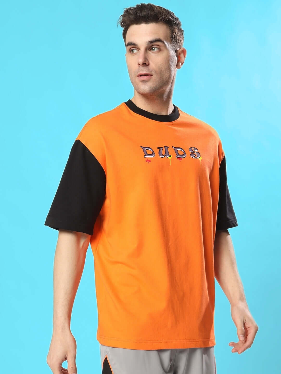 Model wearing COOL TEDDY oversized t-shirt in orange-black, made from premium cotton French terry. 240 GSM bio-washed fabric.