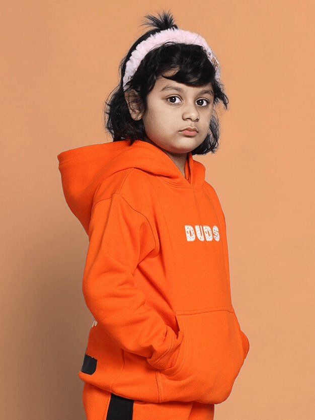 Child wearing Courage Oversized Hoodie Boys & Girls Orange, styled for comfort and confidence