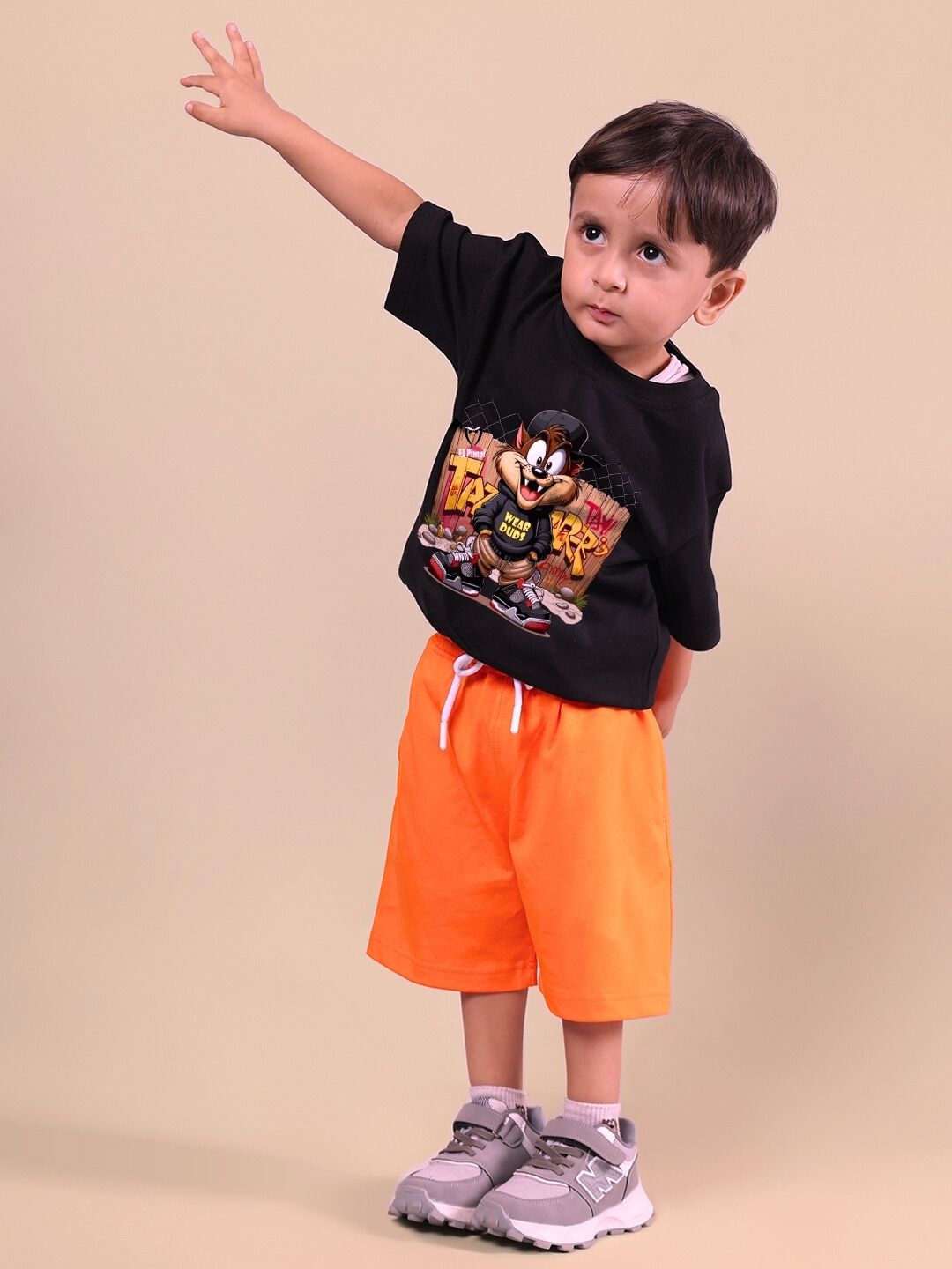 Child wearing black and orange Crazy Rapper co-ord set, trendy street-style outfit for boys and girls.