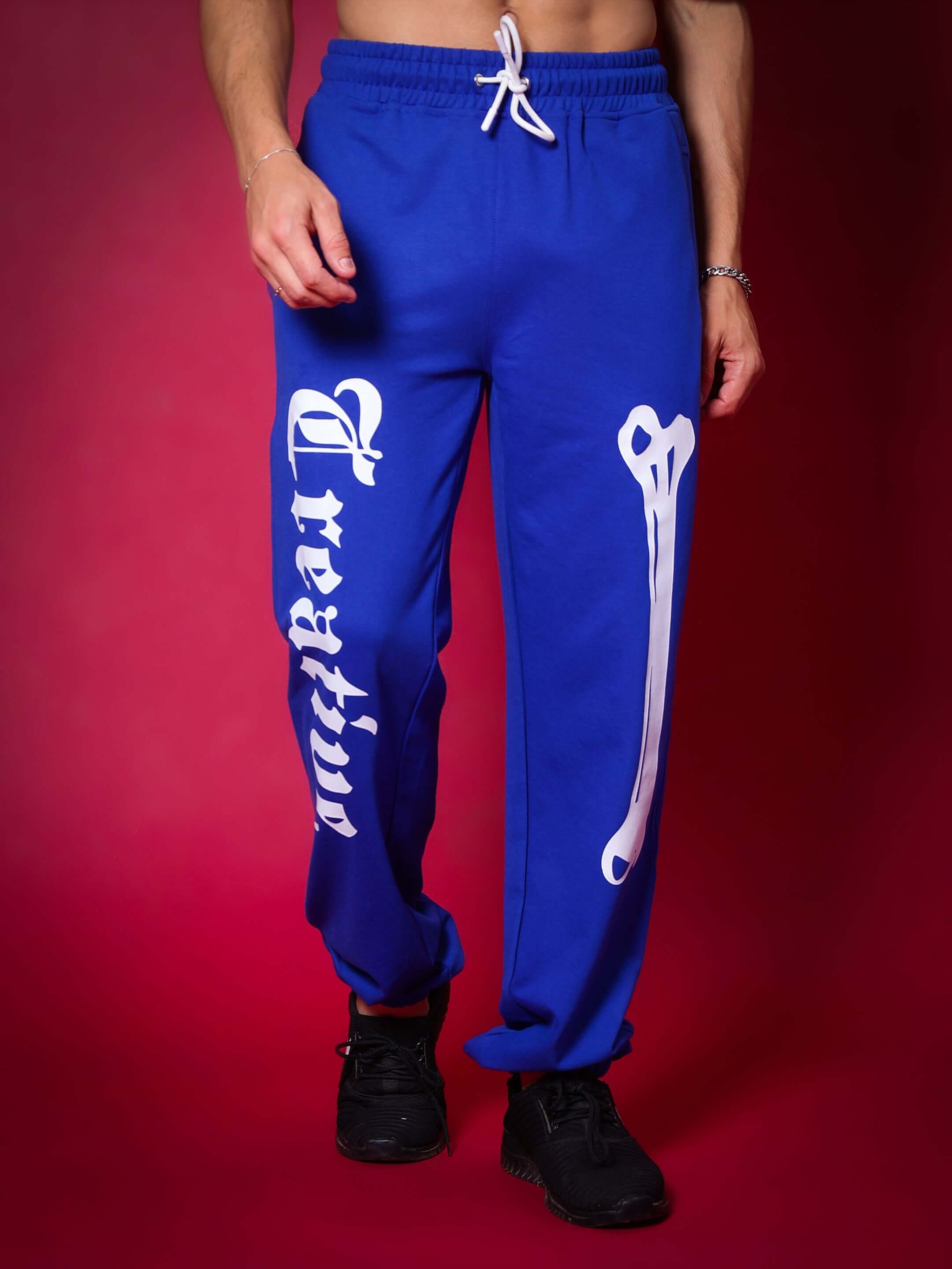 Model wearing Creative Relaxed Jogger Pant in Royal Blue with white lettering.