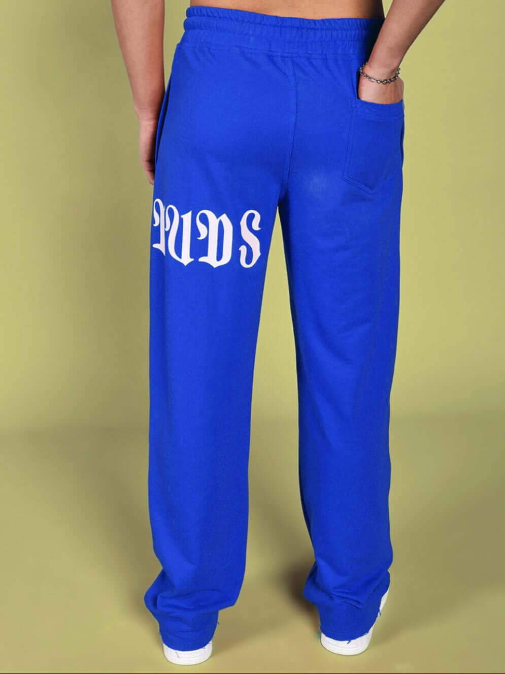 Back view of blue CRIMSON relaxed fit jogger with "DUDS" logo, showcasing comfortable design and custom fit options.