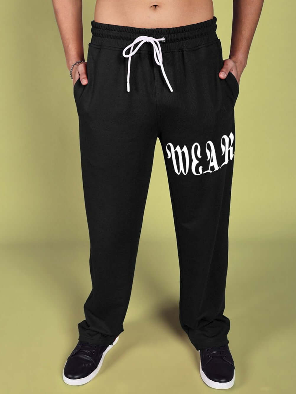 Model wearing CRIMSON Relaxed Fit Jogger in black with white drawstring, featuring 'WEAR' print, customizable size option available.