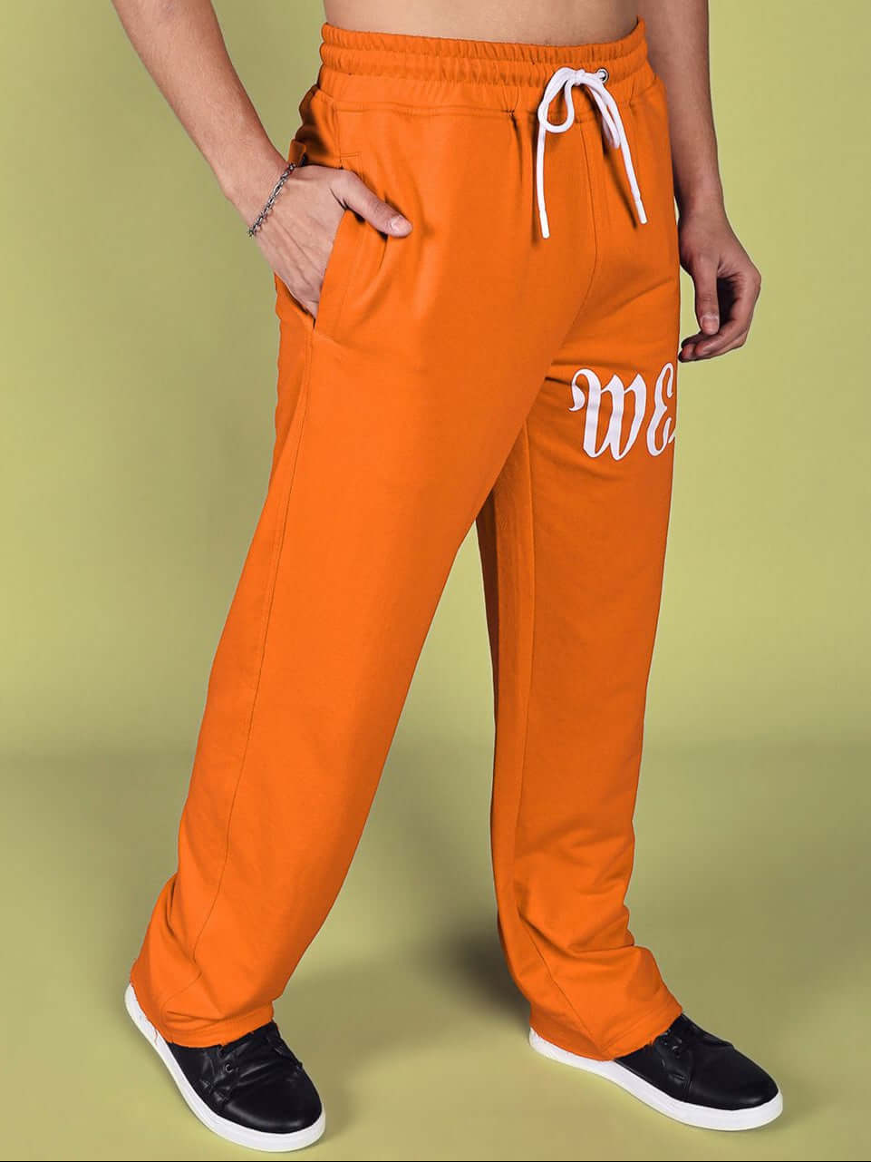 Person wearing Crimson Relaxed Fit Jogger in Orange with drawstring waistband and side pockets, perfect for custom fit options.