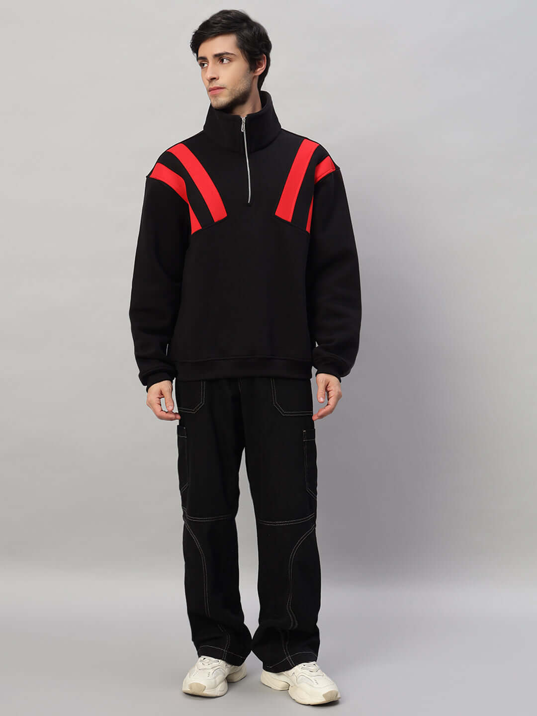 Model wearing a Crossbar Fleece Colorblock Jacket in black-red, featuring a front zipper and oversized fit, paired with black pants.
