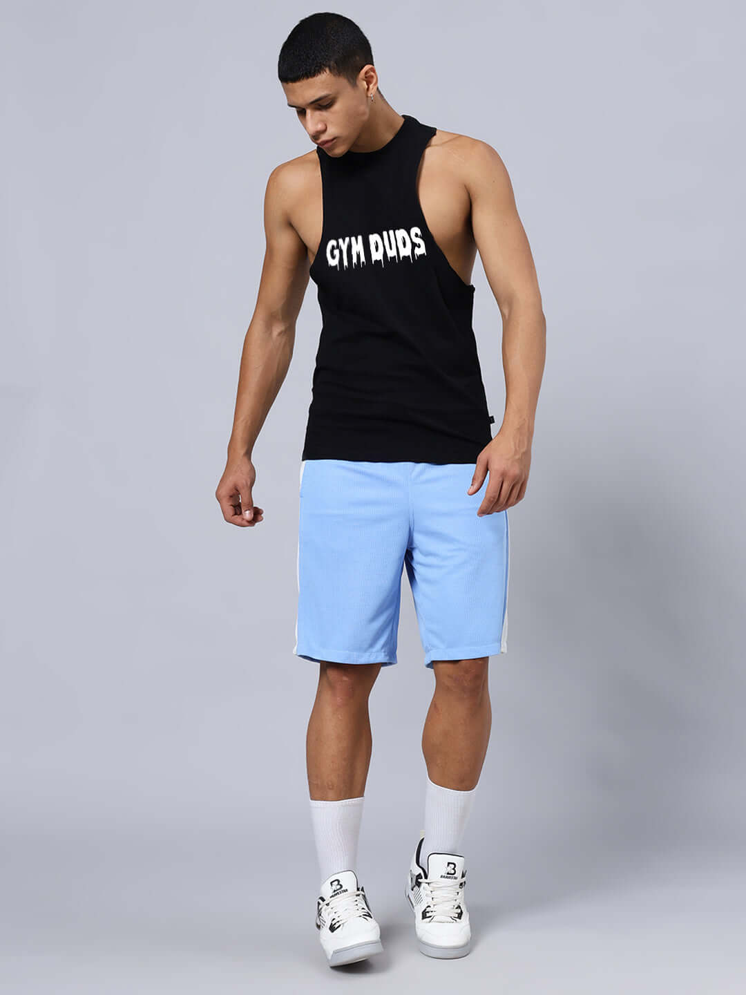 Man wearing CRUNCH GYM CO-ORD SET BLACK-BLUE with gym apparel in black top and blue shorts, showcasing activewear style.