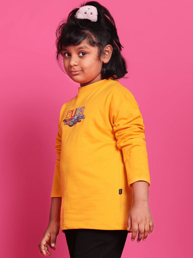 Child wearing a yellow oversized CUBE sweatshirt from DUDS, ideal for boys and girls, available for custom fit and made to order.