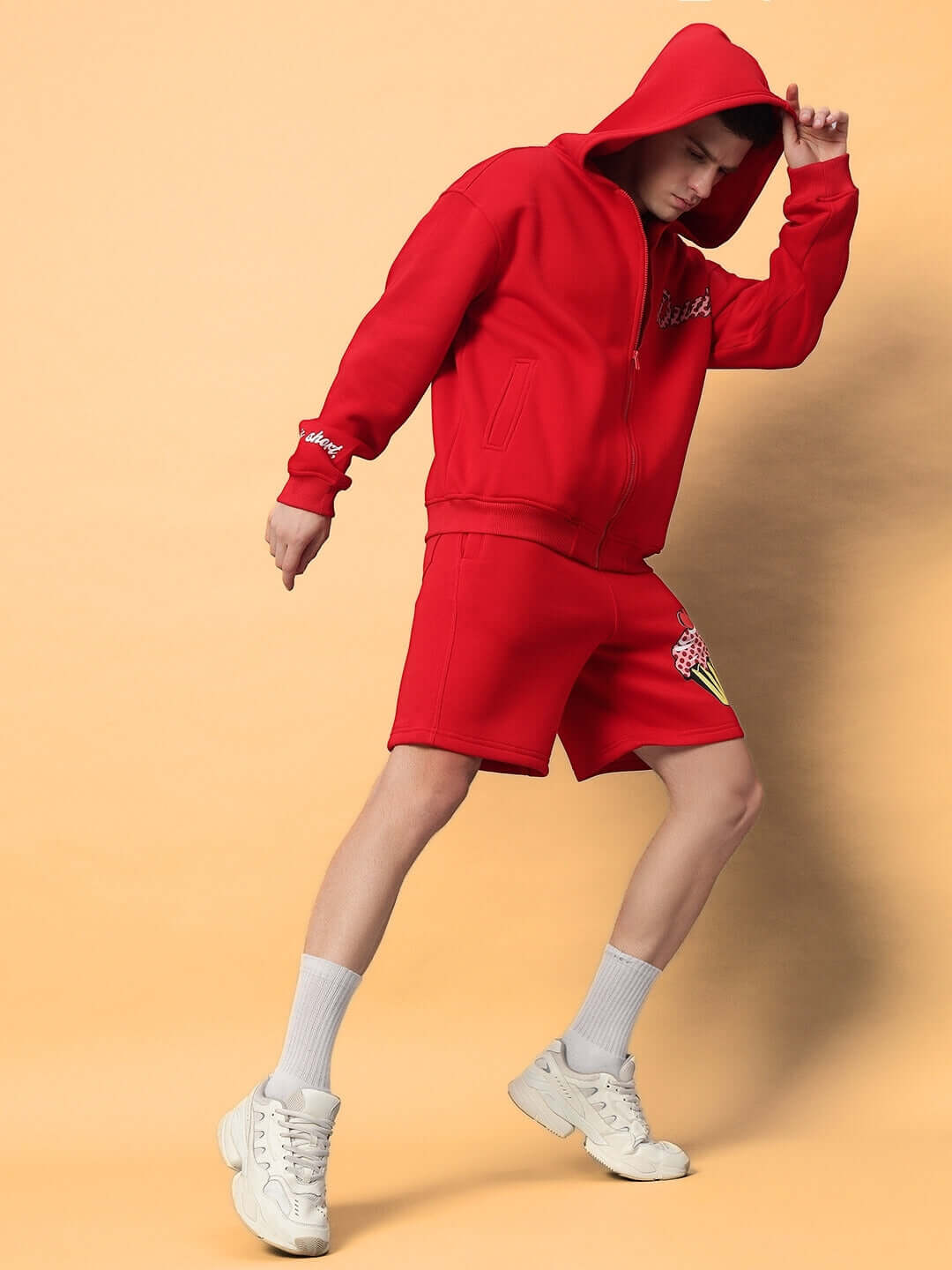 Model wearing red Cupcake Fleece Co-ord, featuring hoodie and shorts. Made to order with custom fit options by DUDS.