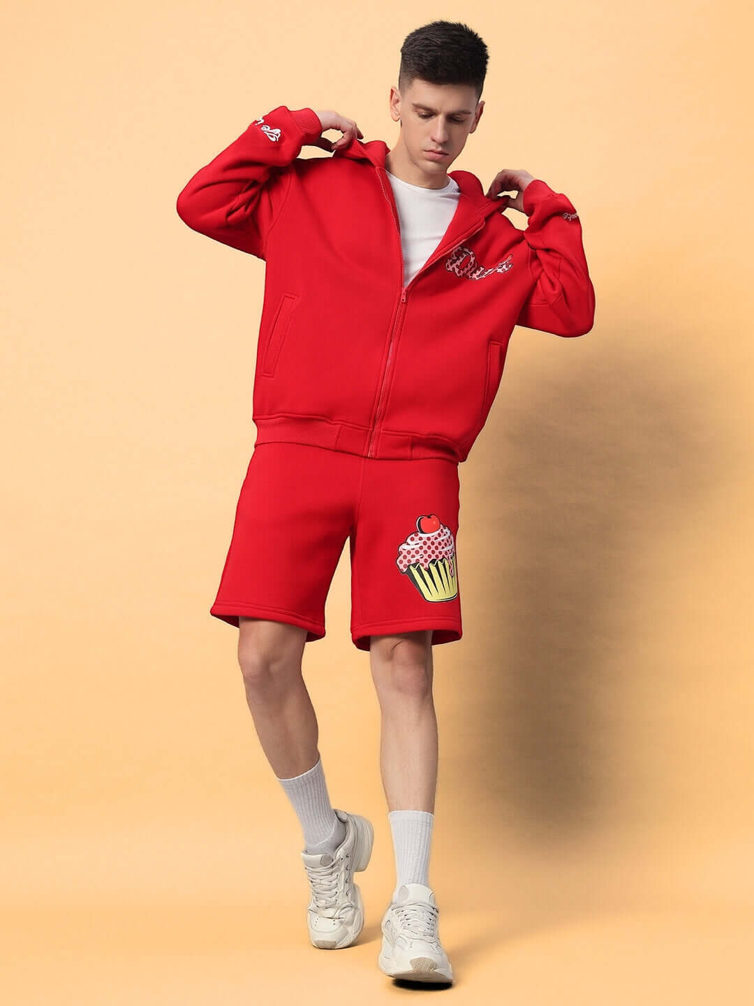 Model wearing CUPCAKE COTTON FLEECE CO-ORD RED, showcasing stylish red streetwear set with cupcake graphic, perfect for cozy chic outfits.