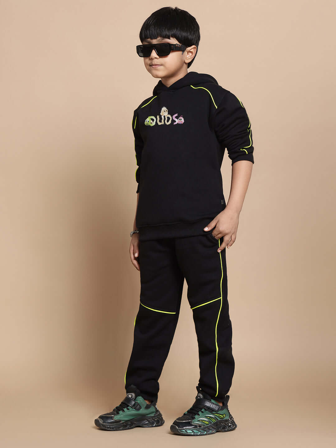 Child wearing black Angry Bird fleece co-ord with neon accents, standing confidently.