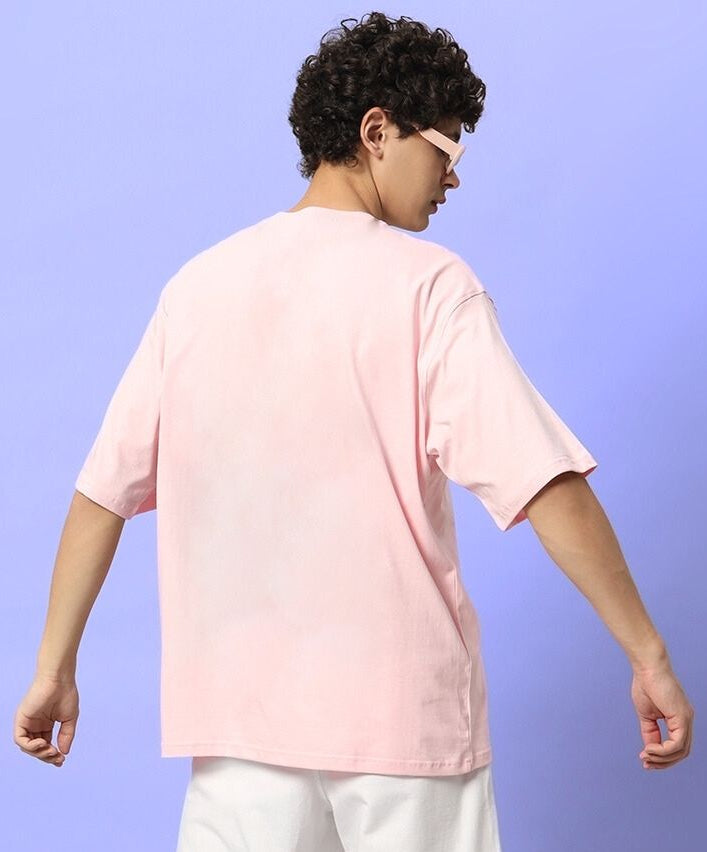 Person wearing CUTE BEAR OVERSIZED T-SHIRT PINK viewed from the back, against a blue background.