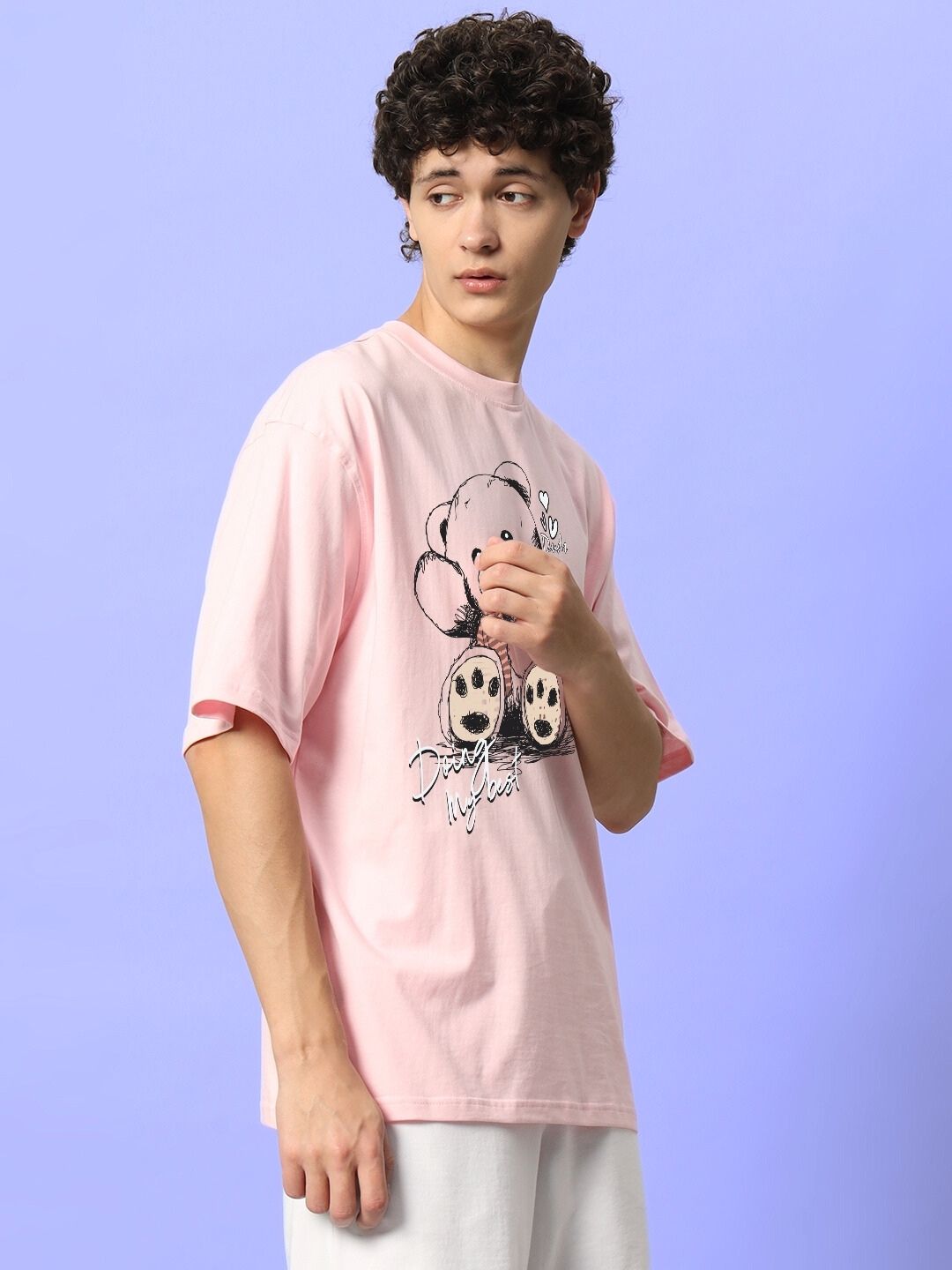 CUTE BEAR OVERSIZED T-SHIRT PINK worn by a model against a purple background.