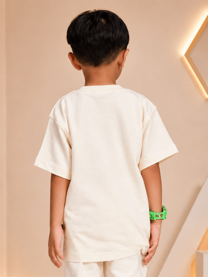 Back view of a child wearing a cute blue puppy oversized t-shirt for boys girls off white, showcasing its loose fit.